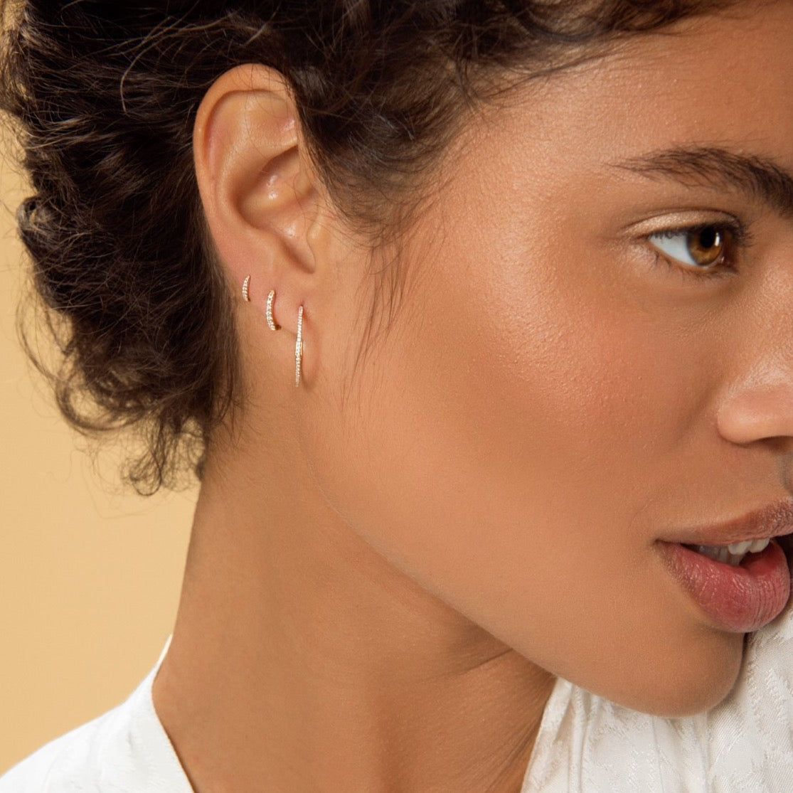 Carolini wearing our Yellow Gold Diamond Huggy, Yellow Gold Diamond Huggy Medium and Diamond Encrusted Yellow Gold Hoop Earrings by McFarlane Fine Jewellery
