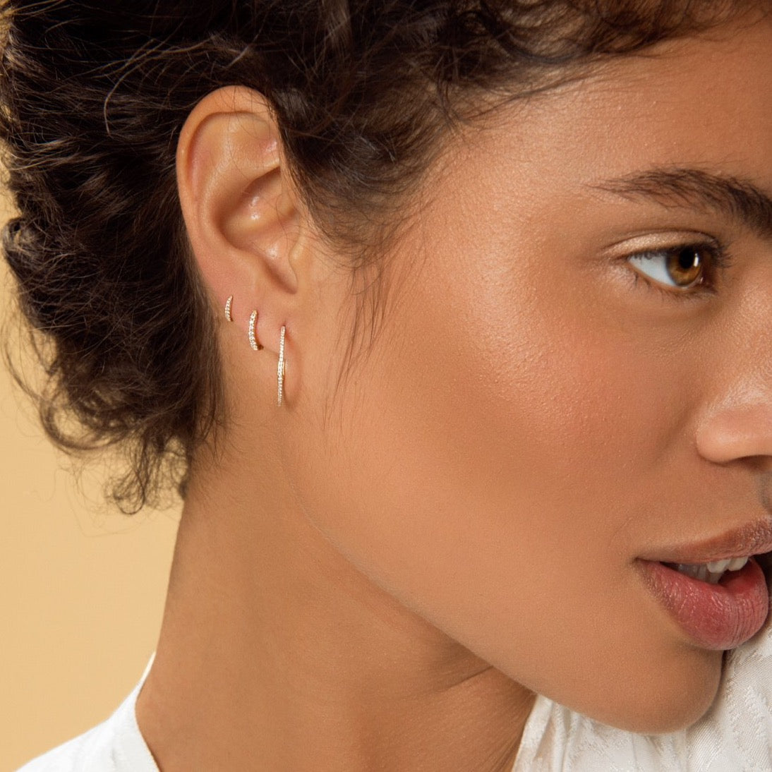 Carolini wearing our Yellow Gold Huggy Medium, Yellow Gold Diamond Huggy and Yellow Gold Diamond Encrusted Hoops by McFarlane Fine Jewellery