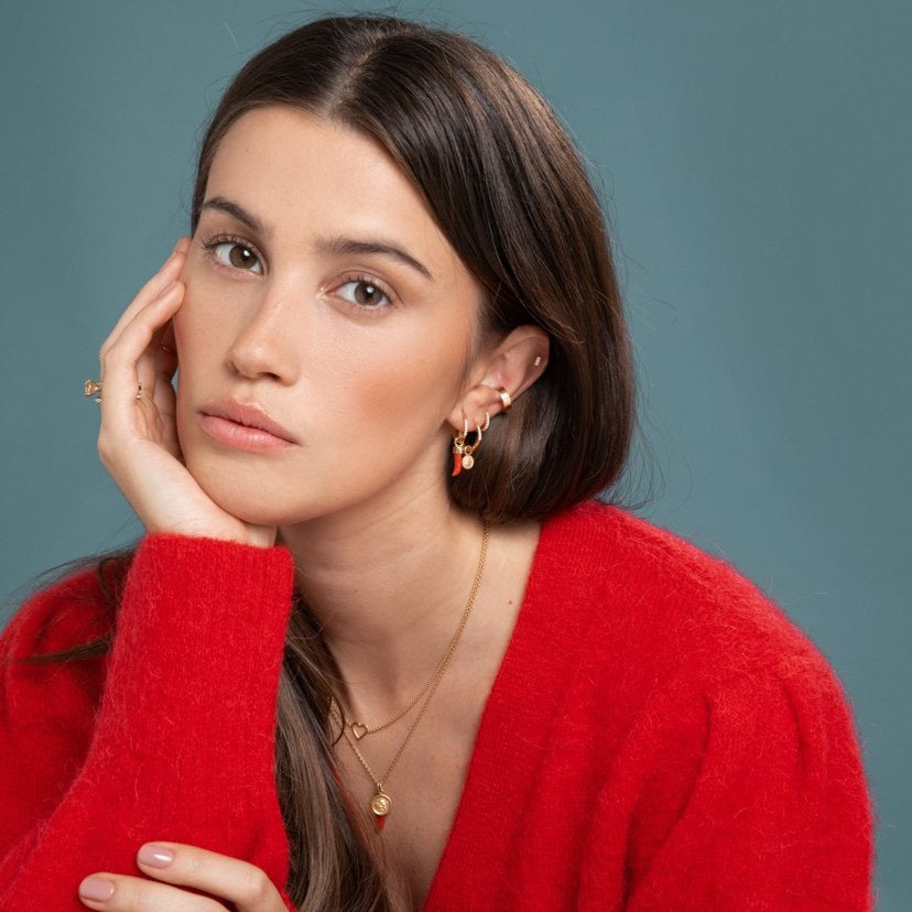 Lilian wearing the Diamond Bar Stud, Gold Ear Cuff, Yellow Gold Diamond Huggy Medium, Diamond Studded Gold Closed Hoop with Angel Pendant, Diamond Studded Closed Hoop with Little Chilli Pendant, the Heart Necklace and the Angel & Little Chilli Necklace by McFarlane Fine Jewellery