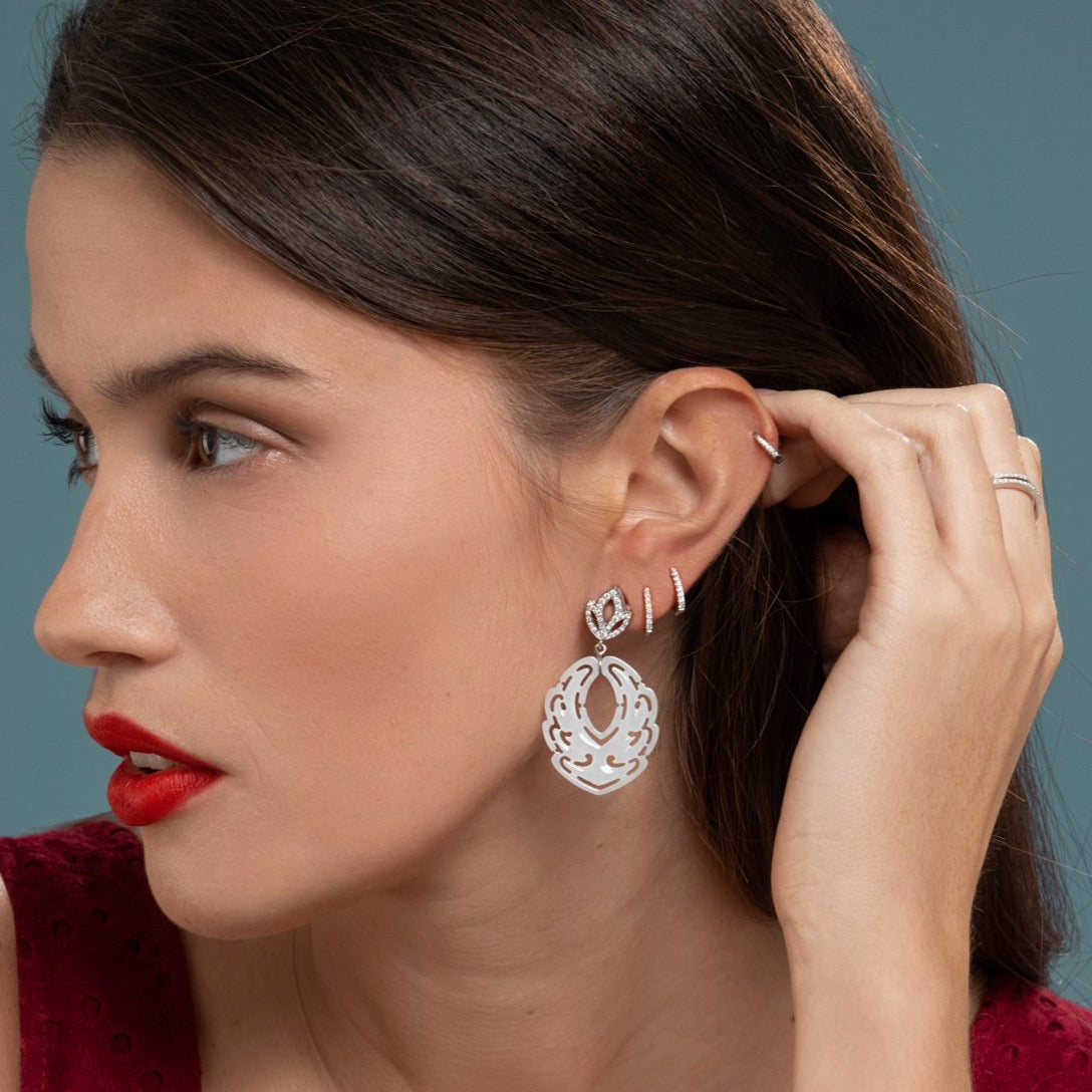 Lilian wearing the Diamond Lotus and White Jade Earrings, White Gold Diamond Huggies Medium and the White Gold Diamond Huggy Small by McFarlane Fine Jewellery
