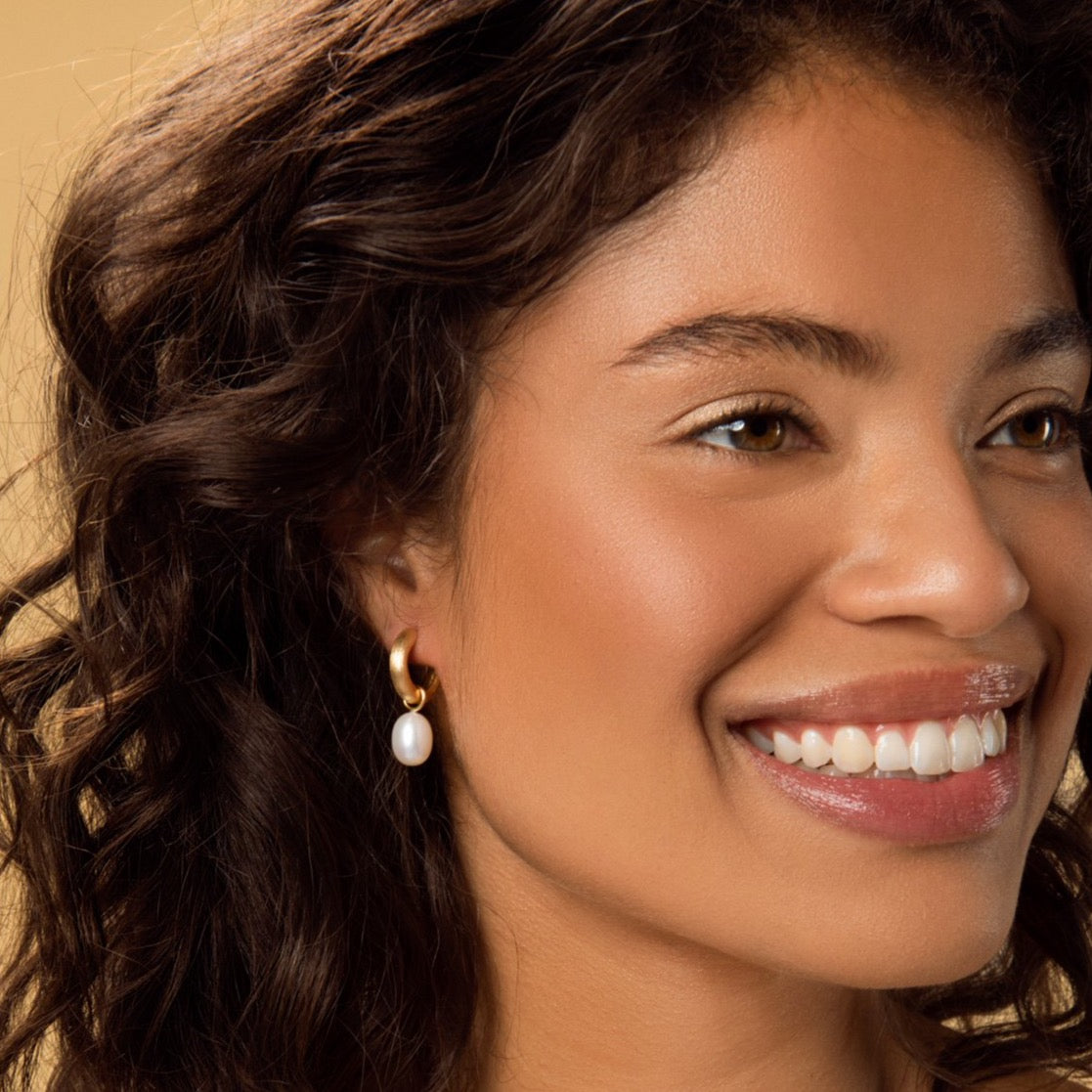 Carolini wearing the Chunky Matt Gold Hoop Earrings with Pearl Pendants by McFarlane Fine Jewellery