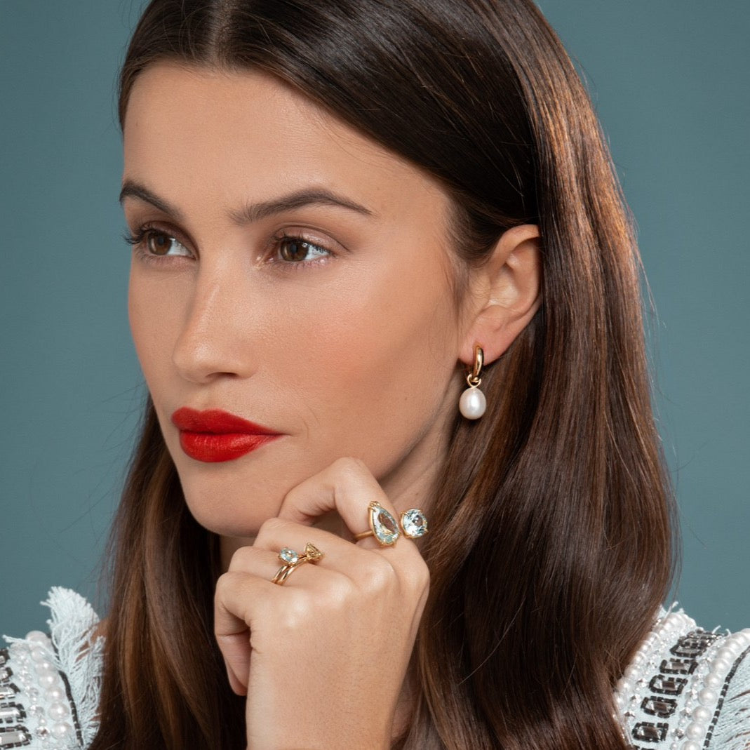 Lilian wearing the Chunky Polished Hoops with Pearls, Aquamarine Duet Ring and the No. 2 and No. 3 Candy Coloured Rings by McFarlane Fine Jewellery