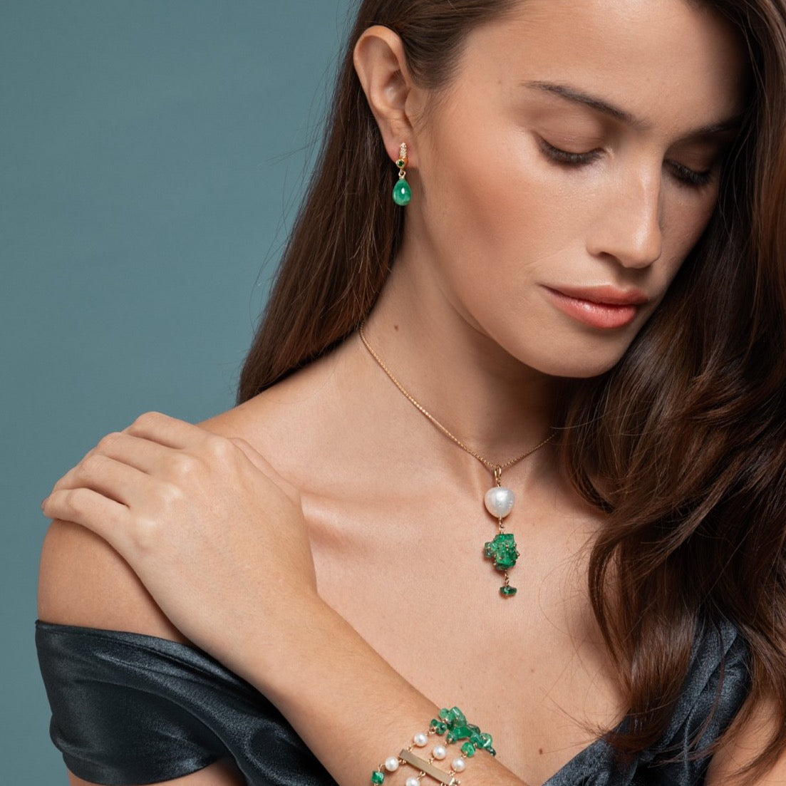 Lilian wearing the Drop Emerald Earrings, Emerald and Pearl Bracelet and the Emerald and Baroque Pearl Necklace by McFarlane Fine Jewellery