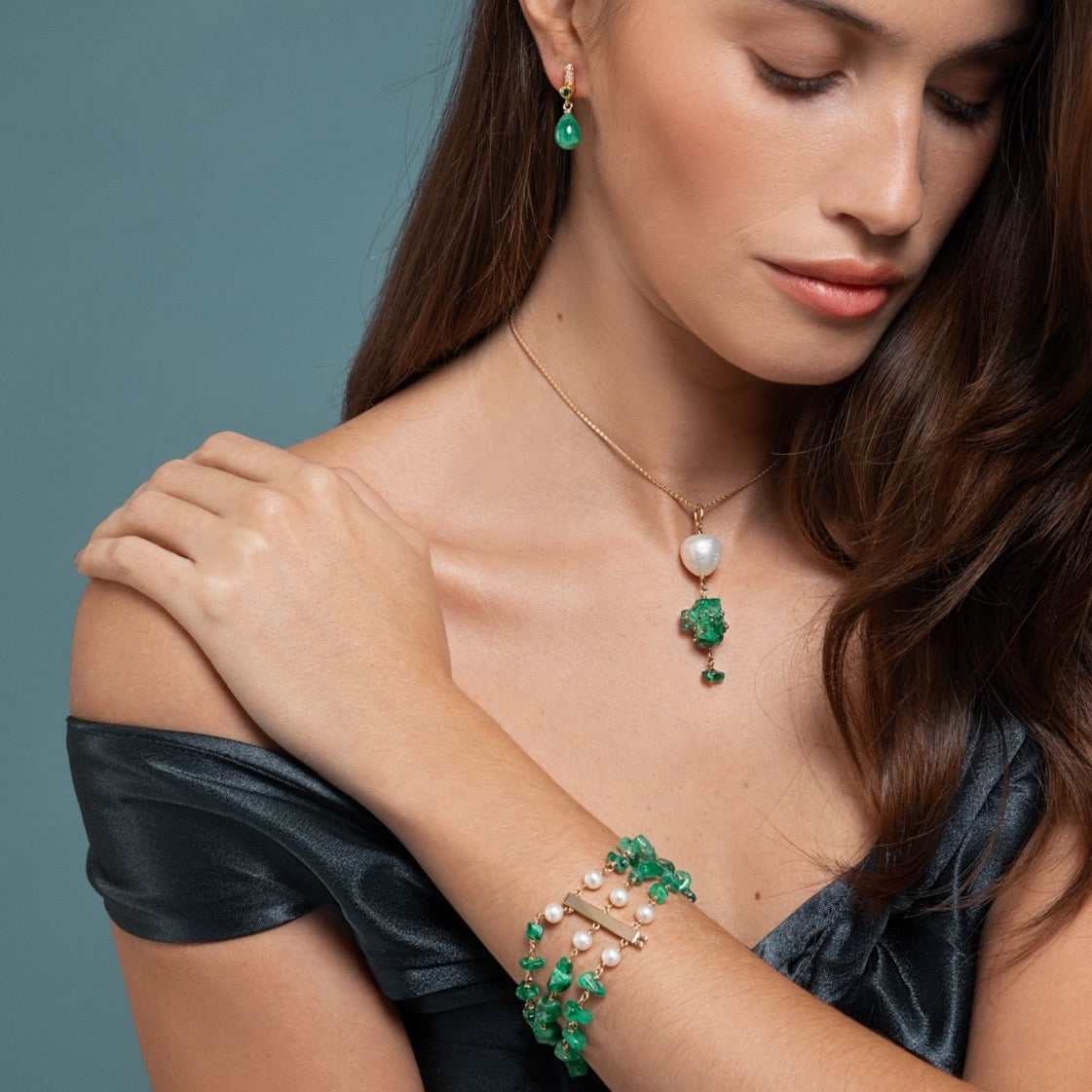 Lilian wearing the Emerald and Pearl Bracelet, Drop Emerald Earring and the Emerald and Baroque Pearl Necklace by McFarlane Fine Jewellery